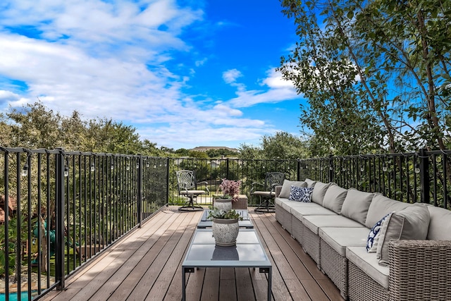 wooden terrace featuring an outdoor hangout area