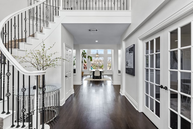 entrance foyer featuring visible vents, baseboards, stairs, french doors, and wood-type flooring