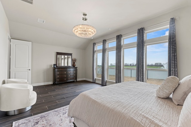 bedroom featuring lofted ceiling, baseboards, a chandelier, and wood finish floors