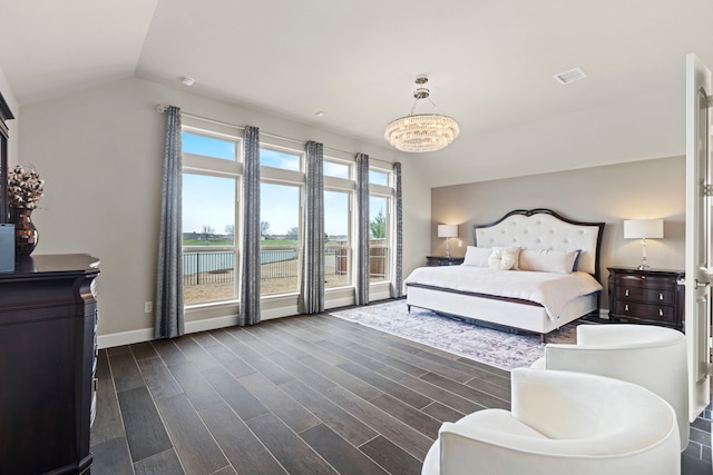 bedroom featuring dark wood-type flooring, a notable chandelier, baseboards, and vaulted ceiling