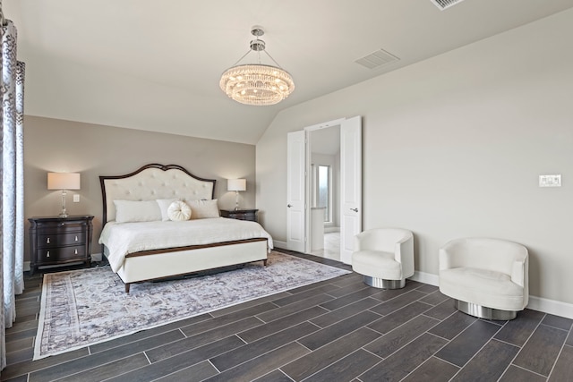 bedroom with visible vents, lofted ceiling, baseboards, a chandelier, and wood tiled floor