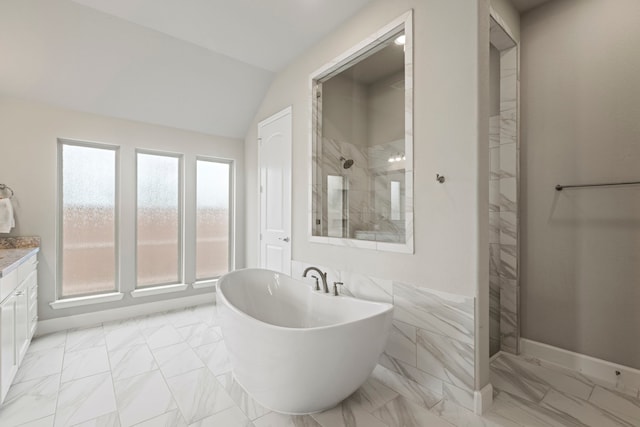 full bathroom featuring lofted ceiling, a soaking tub, marble finish floor, and tiled shower