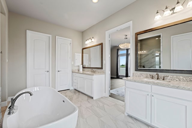 bathroom with two vanities, a stall shower, a soaking tub, marble finish floor, and a sink