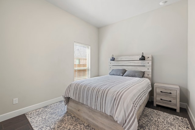 bedroom featuring baseboards and wood finished floors