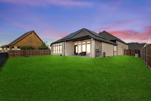 view of yard featuring ceiling fan, a patio, and a fenced backyard