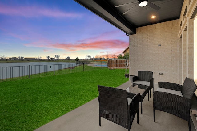 view of yard with a water view, a patio, a fenced backyard, an outdoor hangout area, and ceiling fan