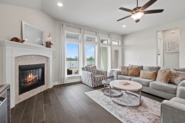 living area with a glass covered fireplace, recessed lighting, dark wood finished floors, and a ceiling fan