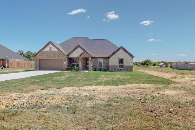 view of front facade featuring brick siding, fence, concrete driveway, a front yard, and a garage