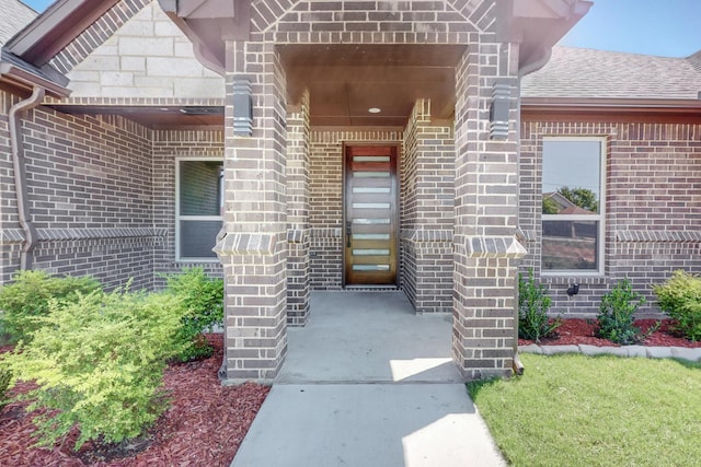 property entrance featuring brick siding