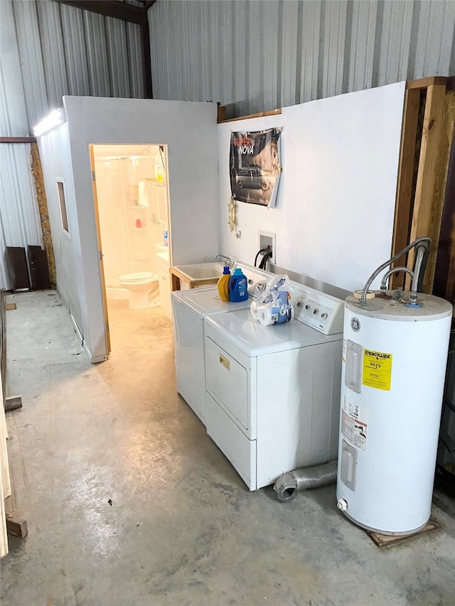 laundry area featuring water heater, laundry area, washer and dryer, and a sink
