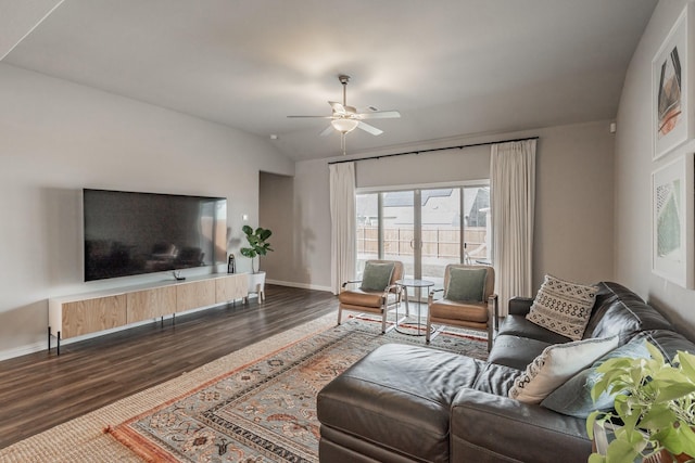 living area with ceiling fan, baseboards, wood finished floors, and vaulted ceiling