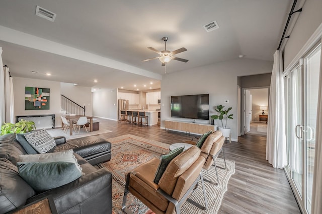 living area featuring visible vents, light wood-type flooring, and ceiling fan