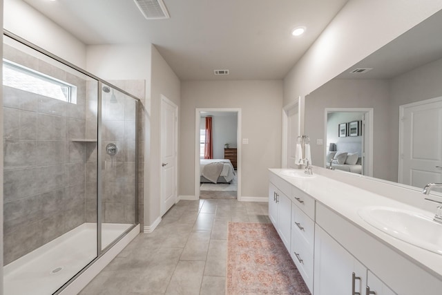 bathroom with double vanity, a stall shower, ensuite bathroom, and a sink