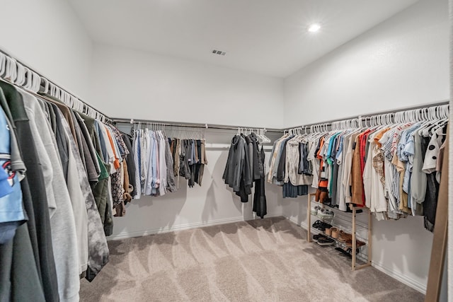 walk in closet with visible vents and carpet