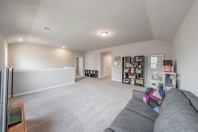 living area with vaulted ceiling, light colored carpet, baseboards, and visible vents