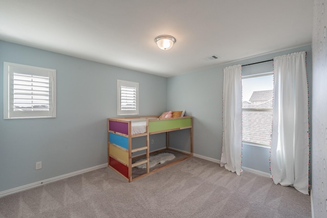 carpeted bedroom featuring visible vents and baseboards