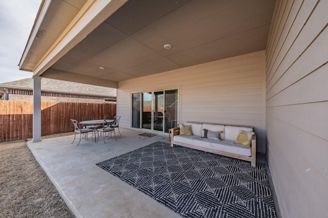 view of patio / terrace with outdoor dining area, an outdoor hangout area, and fence