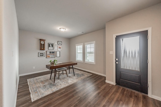 interior space featuring visible vents, baseboards, and dark wood-style floors