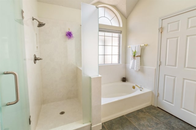 full bathroom with a shower stall, lofted ceiling, and a garden tub