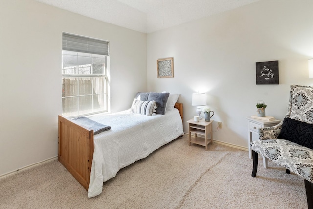 bedroom featuring baseboards and light carpet