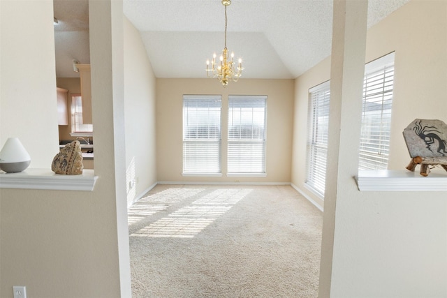 dining room with lofted ceiling, a textured ceiling, an inviting chandelier, carpet flooring, and baseboards