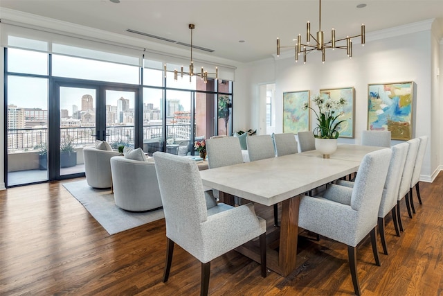 dining area with an inviting chandelier, a view of city, ornamental molding, and dark wood-type flooring