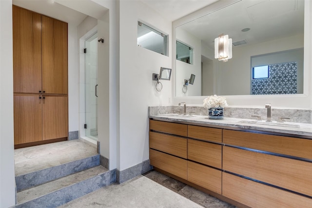 full bath featuring double vanity, visible vents, a stall shower, and a sink