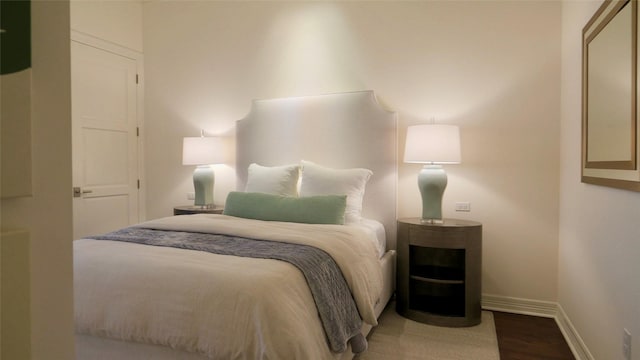 bedroom featuring baseboards and wood finished floors