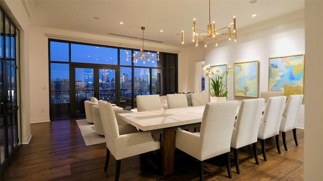 dining area with dark wood-style flooring, a notable chandelier, a view of city, recessed lighting, and baseboards
