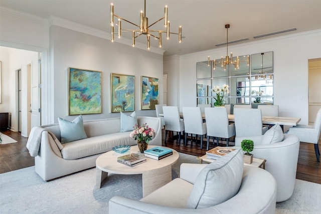 living area featuring visible vents, ornamental molding, wood finished floors, and a notable chandelier