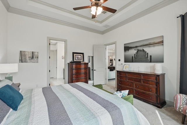 bedroom featuring visible vents, light colored carpet, a raised ceiling, and ornamental molding