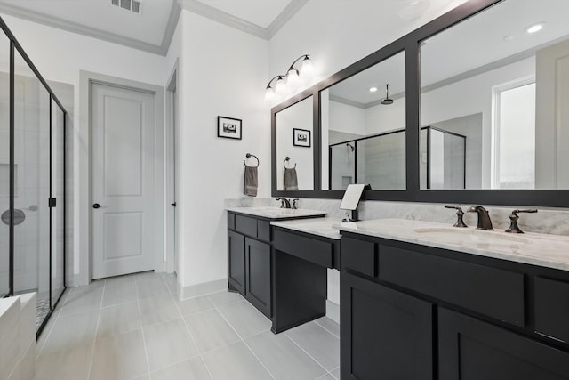 bathroom with tile patterned flooring, crown molding, a stall shower, and a sink