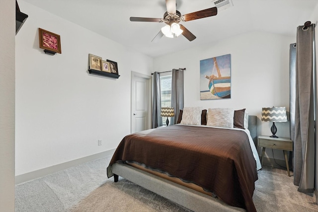 carpeted bedroom featuring a ceiling fan, visible vents, and baseboards