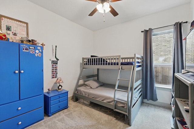 bedroom with light carpet and a ceiling fan