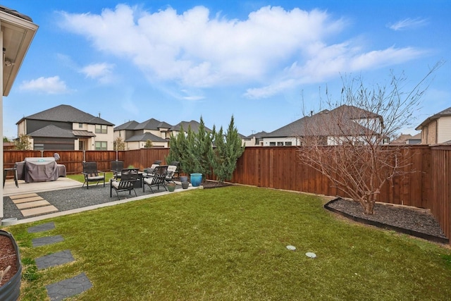 view of yard featuring a patio area, a fenced backyard, and a fire pit