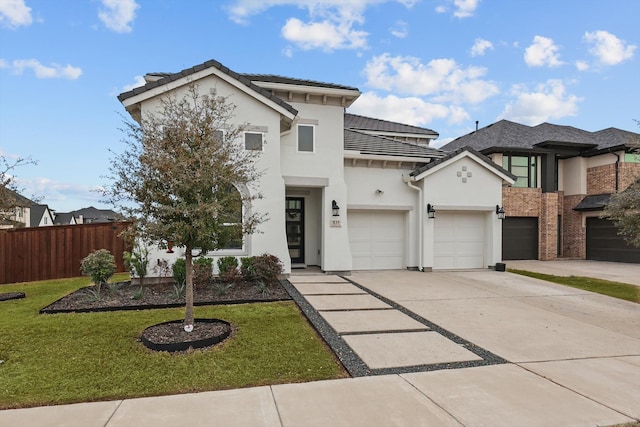 view of front of home featuring stucco siding, concrete driveway, a front yard, and fence