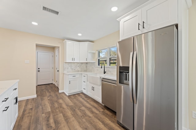 kitchen with visible vents, a sink, open shelves, appliances with stainless steel finishes, and dark wood-style flooring