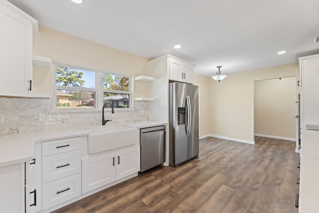 kitchen with a sink, open shelves, stainless steel appliances, white cabinets, and decorative backsplash