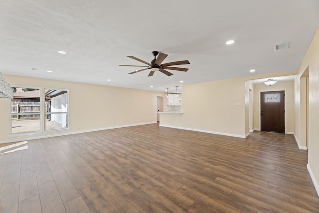 unfurnished living room featuring visible vents, baseboards, a ceiling fan, and dark wood-style flooring