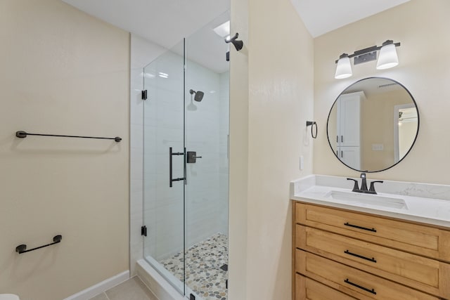 full bathroom with baseboards, a stall shower, vanity, and tile patterned flooring