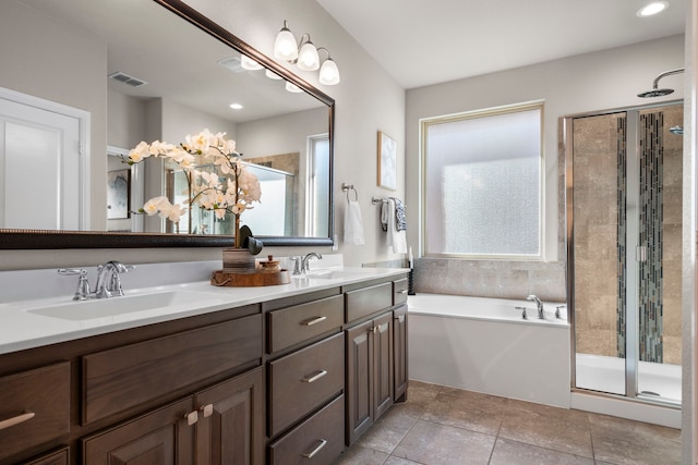 full bathroom featuring a shower stall, a bath, double vanity, and a sink