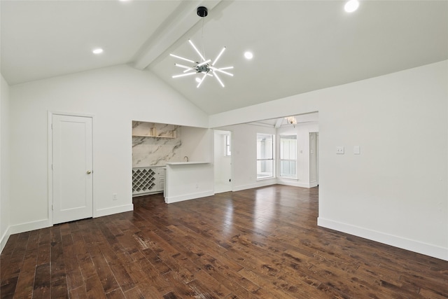 unfurnished living room featuring an inviting chandelier, lofted ceiling with beams, dark wood-style floors, and baseboards