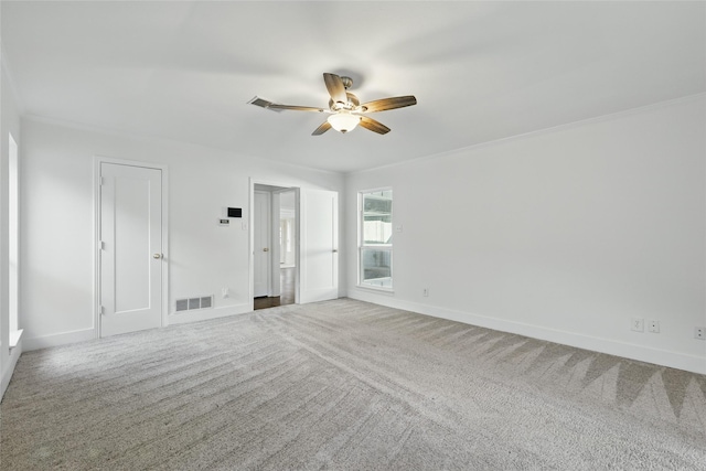 spare room with visible vents, baseboards, carpet, and ceiling fan