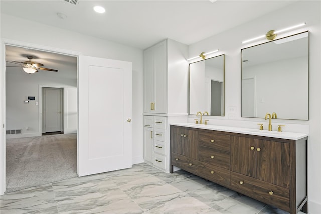 bathroom with a ceiling fan, visible vents, double vanity, a sink, and marble finish floor