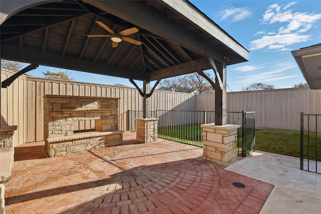 view of patio with a gazebo, fence, and ceiling fan