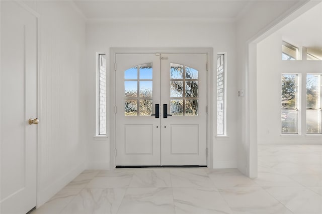 entryway with french doors, baseboards, marble finish floor, and crown molding