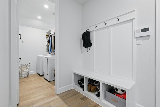 mudroom with recessed lighting, baseboards, wood finished floors, and washing machine and dryer