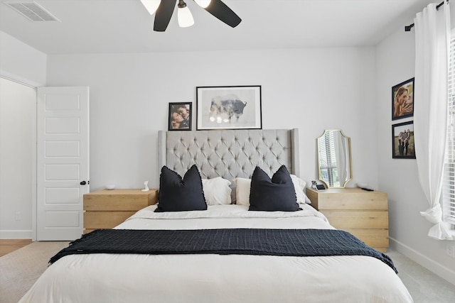 bedroom featuring visible vents, a ceiling fan, carpet, and baseboards