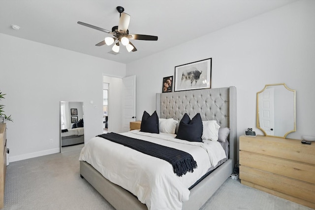 bedroom with ceiling fan, baseboards, and light carpet