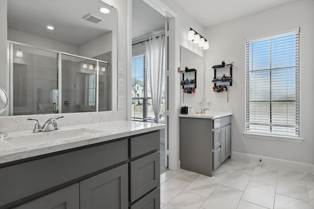 full bath featuring a sink, visible vents, two vanities, and a shower stall